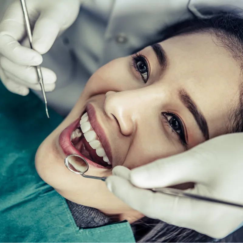 Example to avoid: close-up of a patient with dental instruments in their mouth